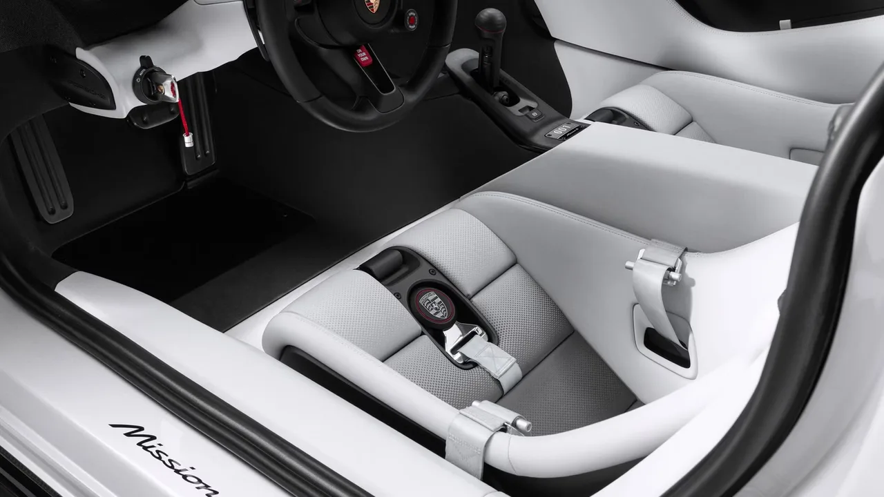 Porsche Mission S interior seen through the open door, with white seats, black dashboard and Mission S script on the sill
