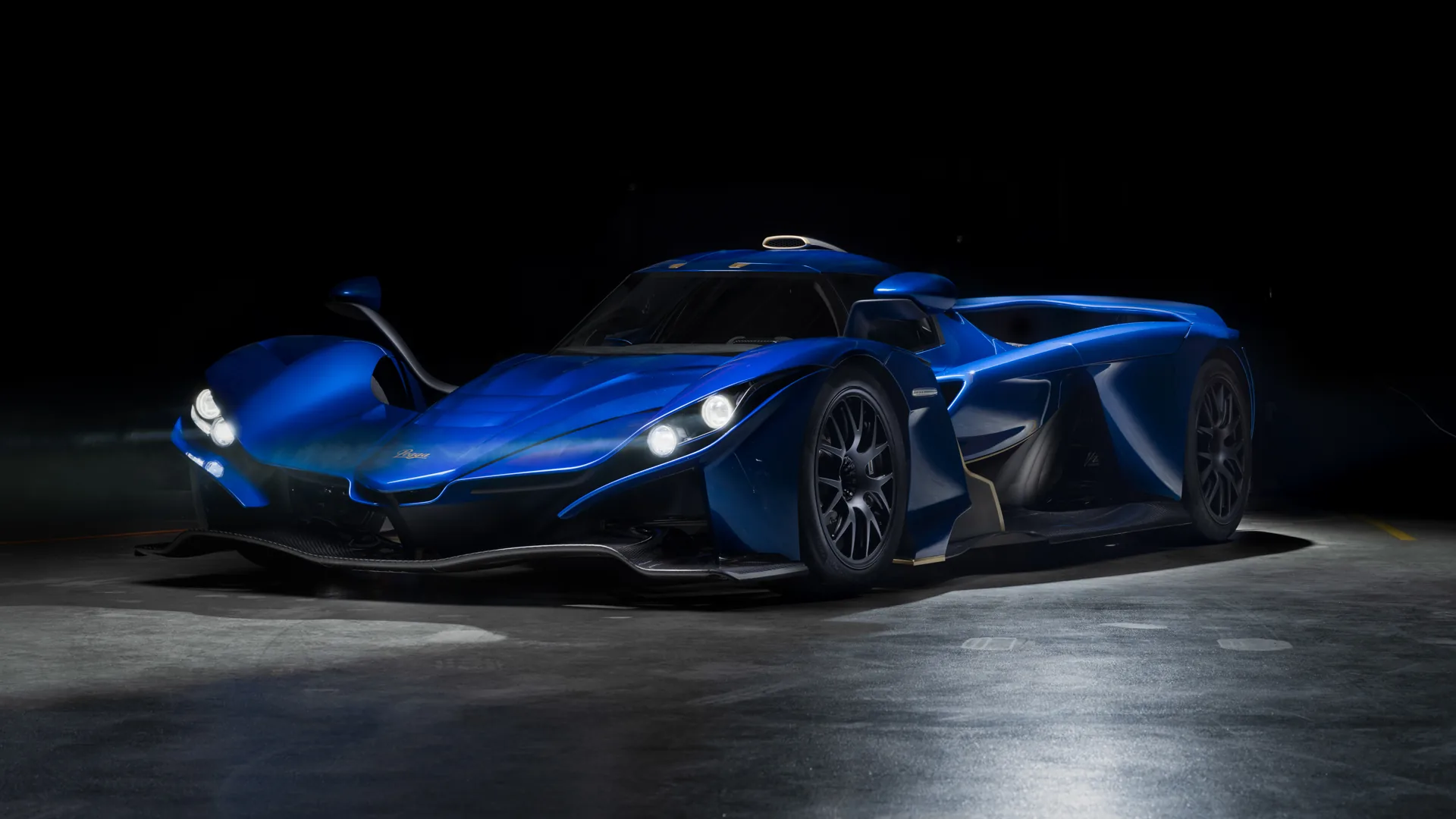 Blue Praga Bohema hypercar, front three-quarter studio view with headlights on