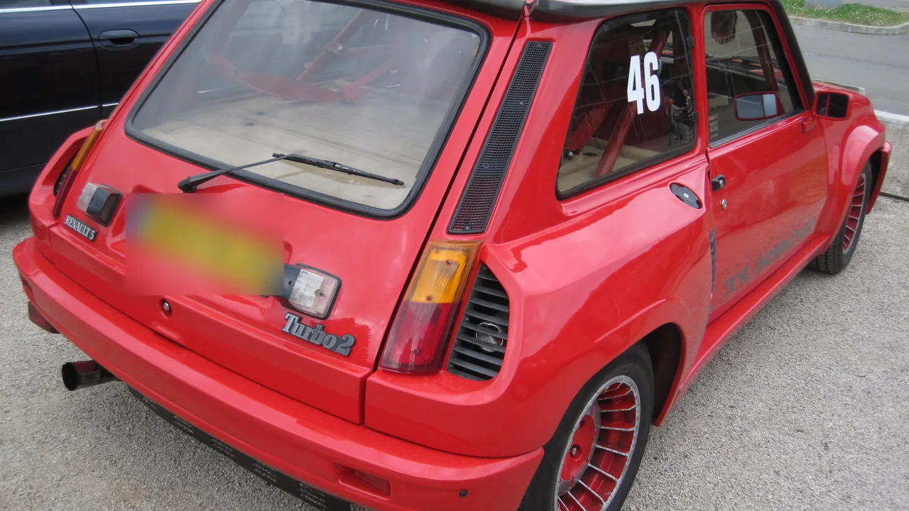 Rear of an original red Renault 5 Turbo 2 showing the huge hips, side air intakes and Turbo 2 badge