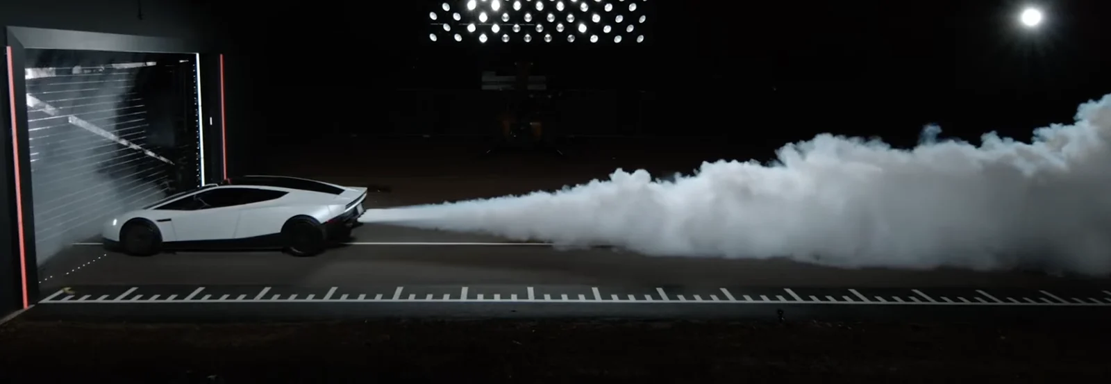 Live SpaceX package demo: the Roadster fires its rear cold-gas thrusters, leaving a long plume of gas behind it.