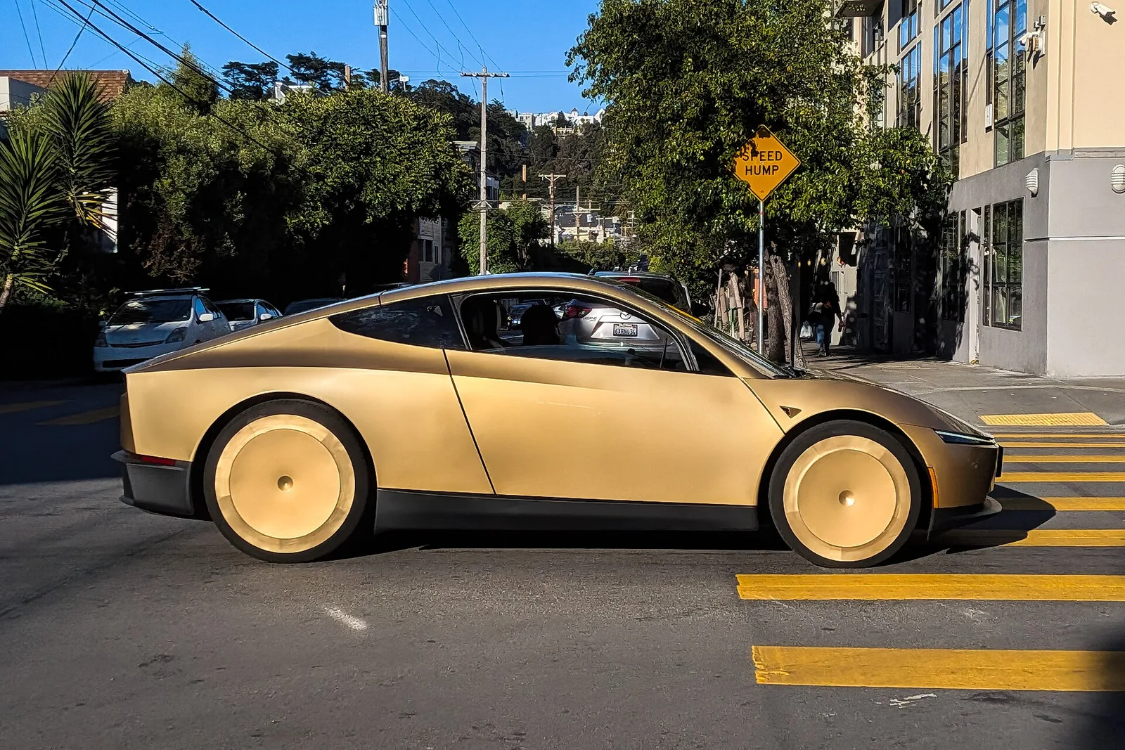 A Tesla Cybercab driving down a street in San Francisco in June 2026