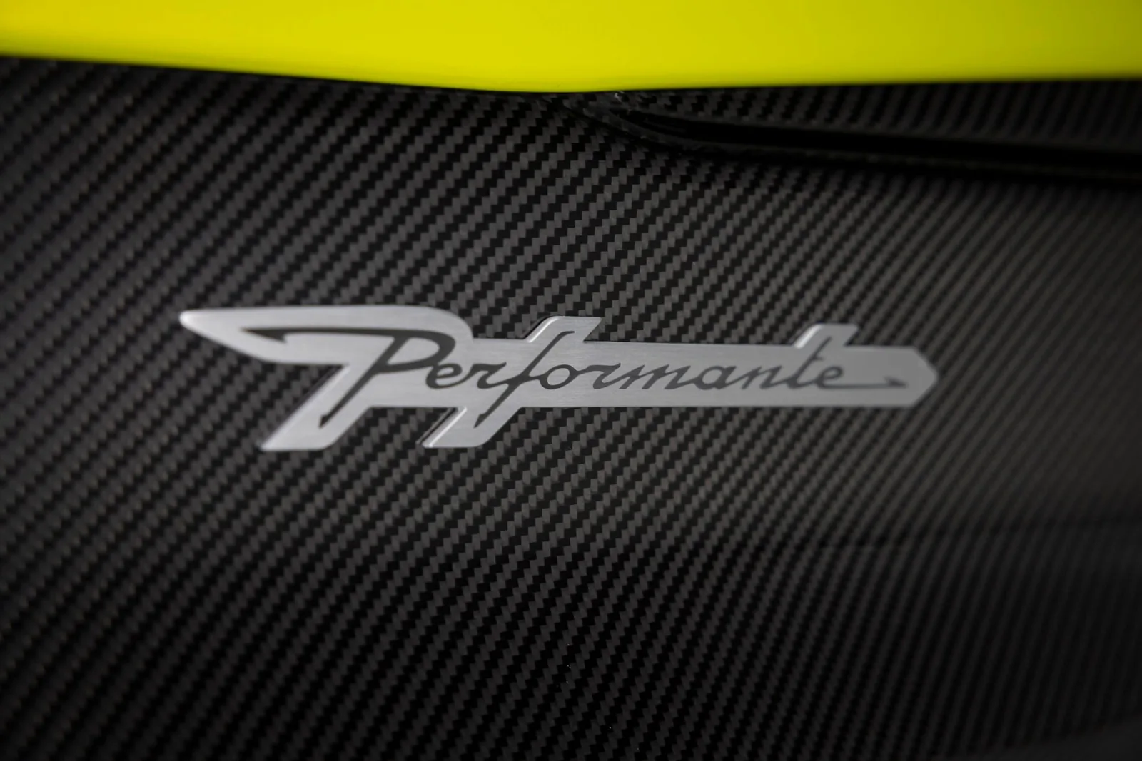Lamborghini Urus SE Performante carbon-fiber Performante badge close-up on the side of the SUV