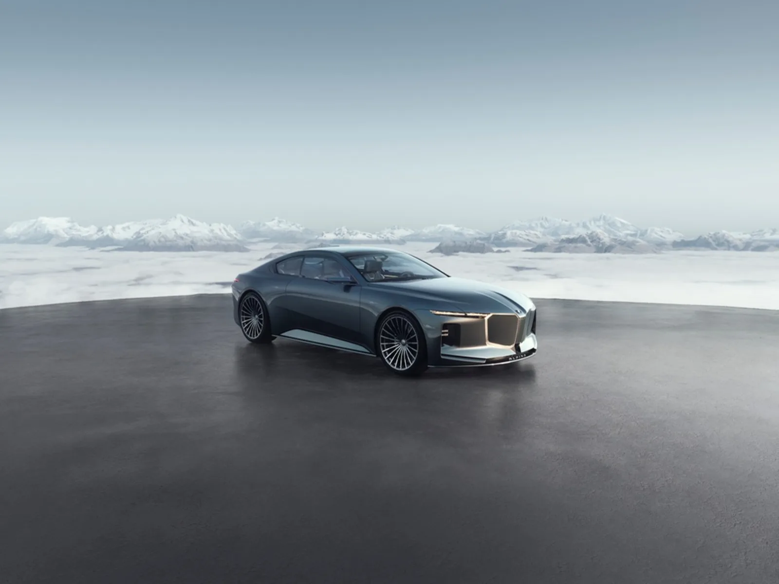 Vision BMW Alpina concept front view with snow-capped Alpine mountains in the background — illuminated shark-nose kidney grille and warm white daytime running lights