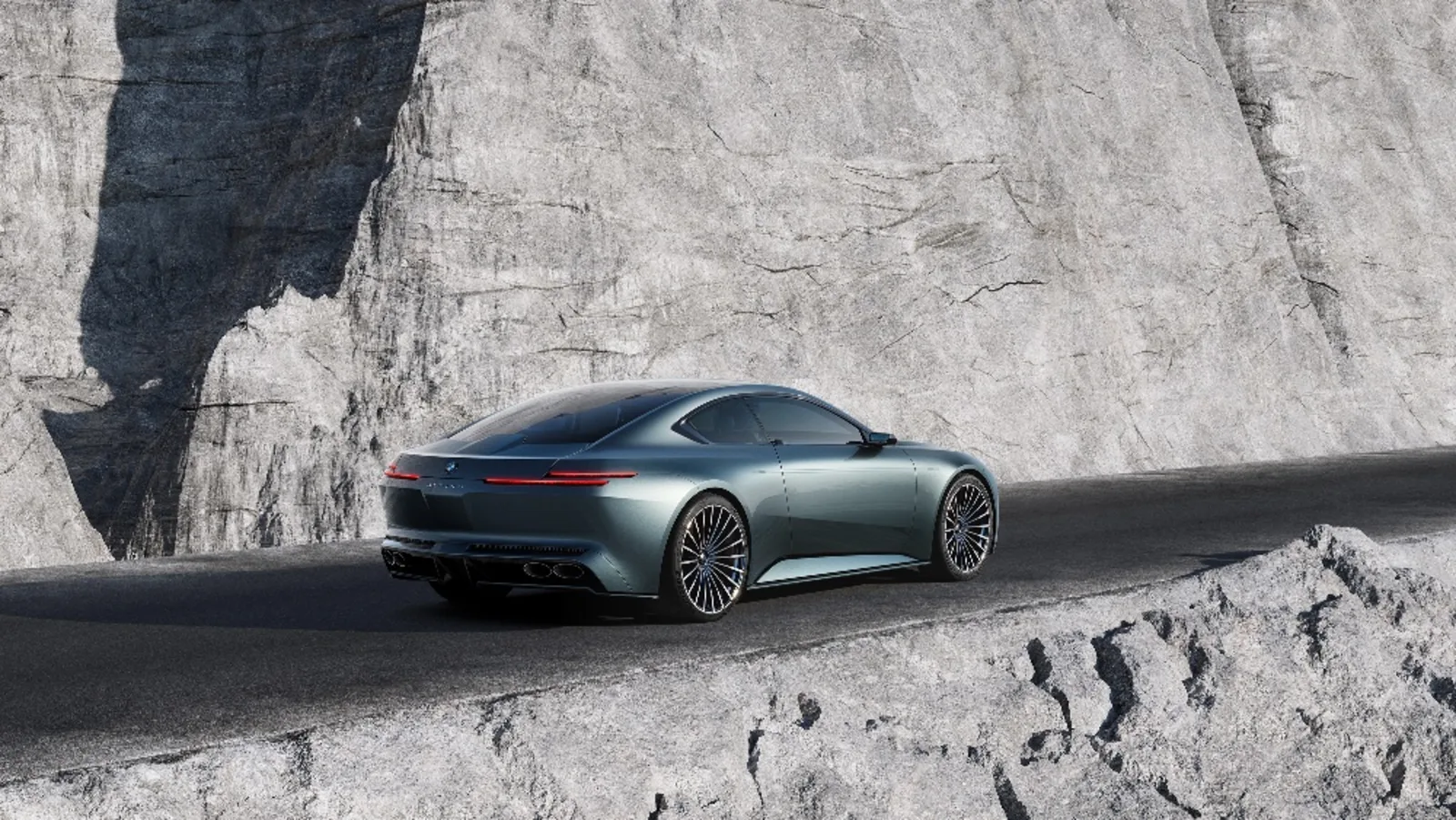 Vision BMW Alpina rear three-quarter view on rocky alpine road — two-line taillight motif and elliptical quad exhaust outlets
