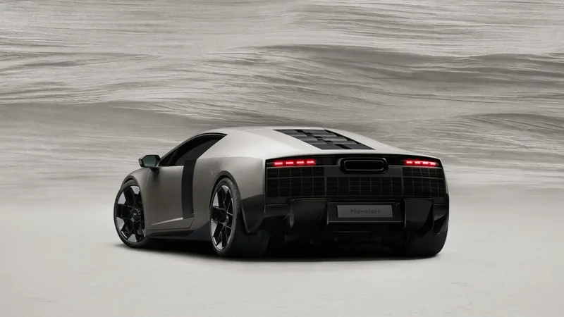 Audi Nuvolari 2027 rear three-quarter side view in Titanium colour with deployable rear wing — 1,001 PS V8 biturbo plug-in hybrid supercar, revealed at Audi Summit in Antibes on June 4, 2026