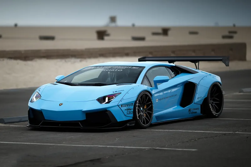 Liberty Walk LB-Works Lamborghini Aventador in light blue with wide fender flares and a swan-neck GT wing