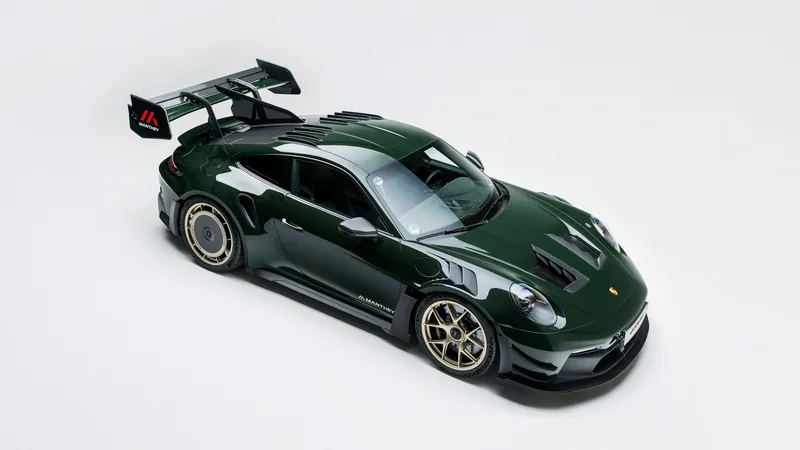 Dark green Porsche 911 GT3 RS with Manthey Kit seen from above, with large Manthey rear wing, louvred wings and gold wheels