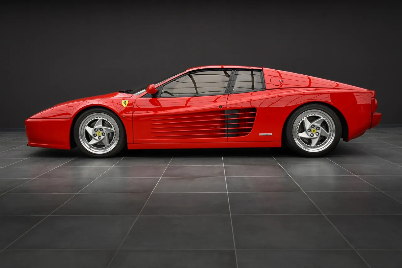 Red Ferrari 512 M Testarossa front three-quarter view in a dark studio, 4K desktop wallpaper